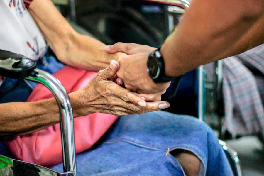 A person's hands resting on a table at home